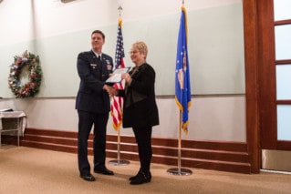 Man and Woman posing in front of flags