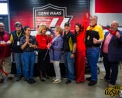 Group photo of people cutting a ribbon inside of the machining lab title Gene Haas Innovation Lab