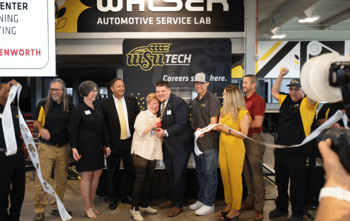 Group of people celebrating at a ribbon cutting at WSU Tech