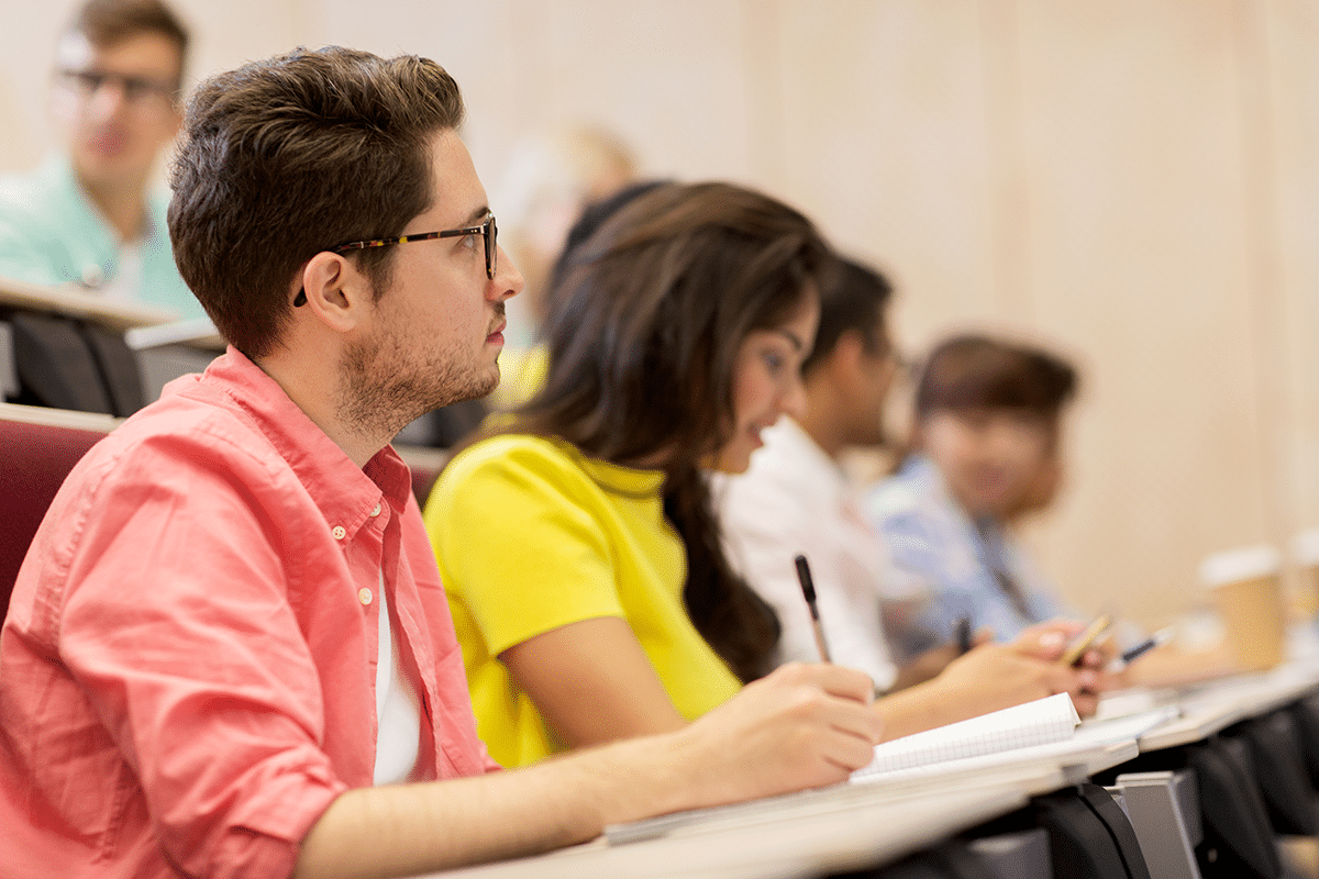 group-of-students-with-notebooks-in-lecture-hall-2024-09-27-19-54-46-utc Students in classroom watching and listening to lecture - Open Education