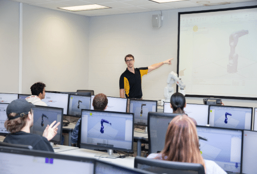 fa-landing-sm-tile-images-2 Instructor teaching robotics to students in a computer lab at WSU Tech