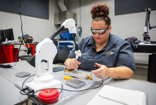 fa-landing-sm-tile-images-3 Student working with robotic arm equipment in a WSU Tech lab