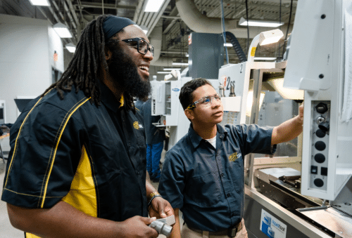 fa-landing-sm-tile-images Two WSU Tech students working together on a machine in a lab