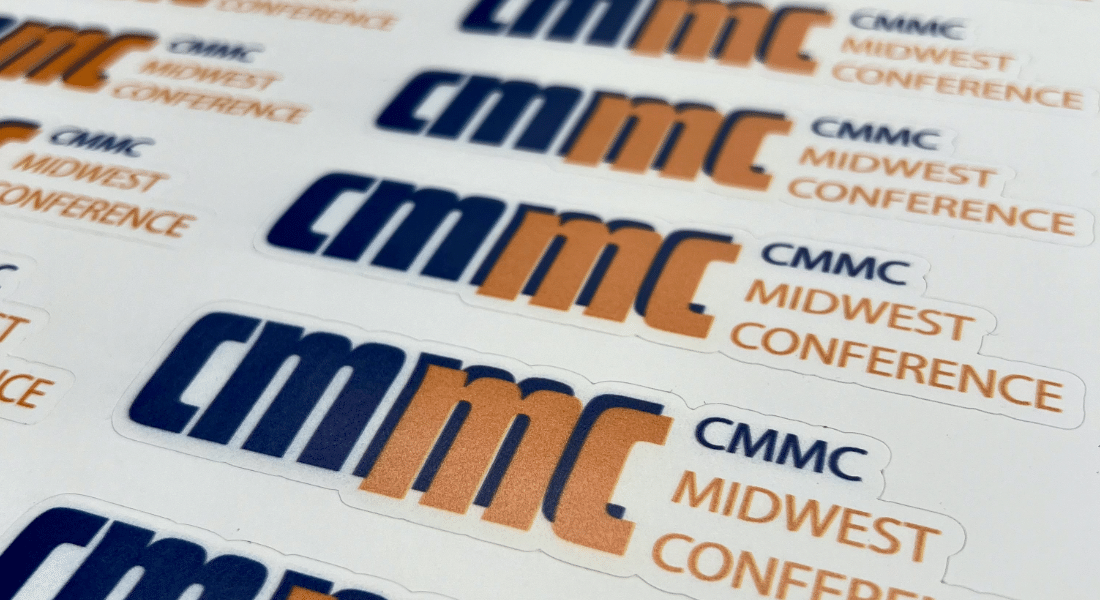 shock-starter-graphic-design-main-3 Close-up of stickers printed with the logo and text ‘CMMC Midwest Conference’ in blue and orange.