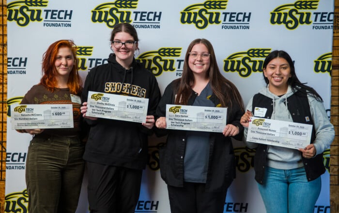 Picture of WSU Tech Students holding oversized checks