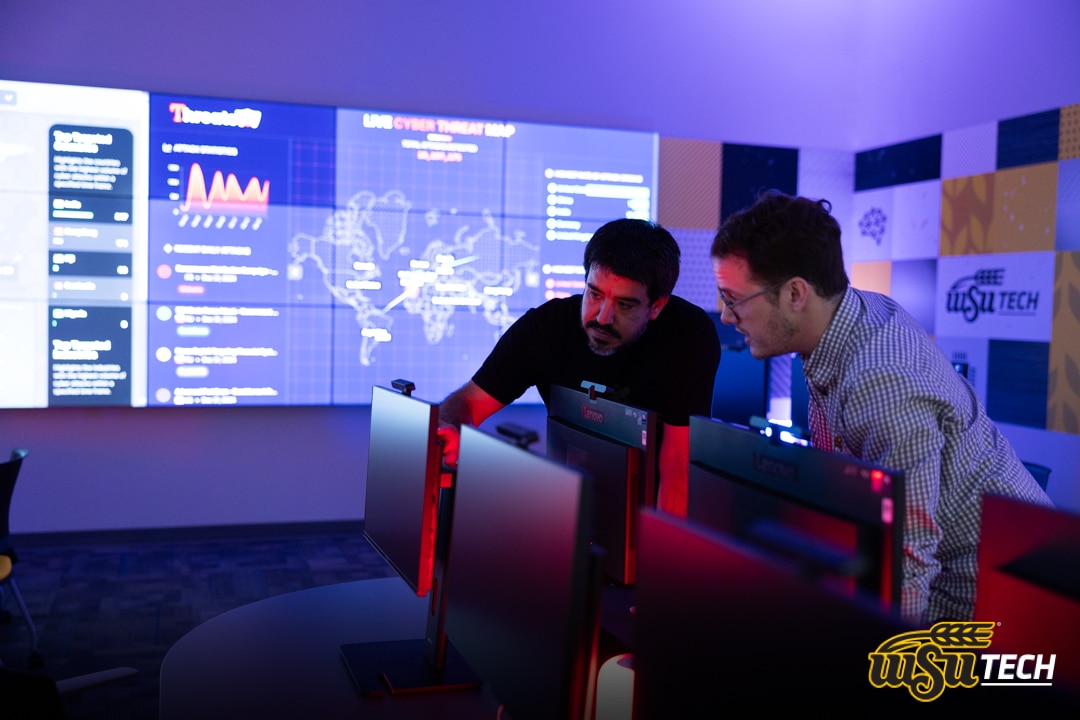 Photo of two males looking at a computer in WSU Tech Cyber Range