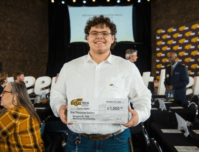 WSU Tech Foundation scholarship recipient with check at awards luncheon.
