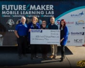WSU Tech and GoodWill Kansas team members stand in front of FutureMaker Mobile Learning Lab trailer holding a big check for $10k.