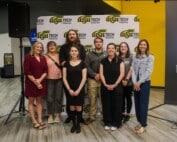 A group of 6 female adults and 2 male adults pose in front of a WSU Tech Foundation backdrop.