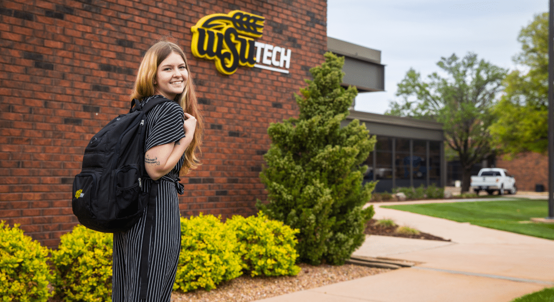 student-resources-hub-academics Student walks across campus with a backpack, representing access to academic policies, student resources, and course information.