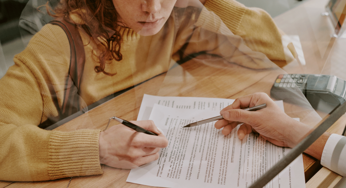 student-resources-hub-emergency-student-loans Student reviews financial assistance paperwork, representing emergency student loans and scholarship opportunities available to help students stay on track.