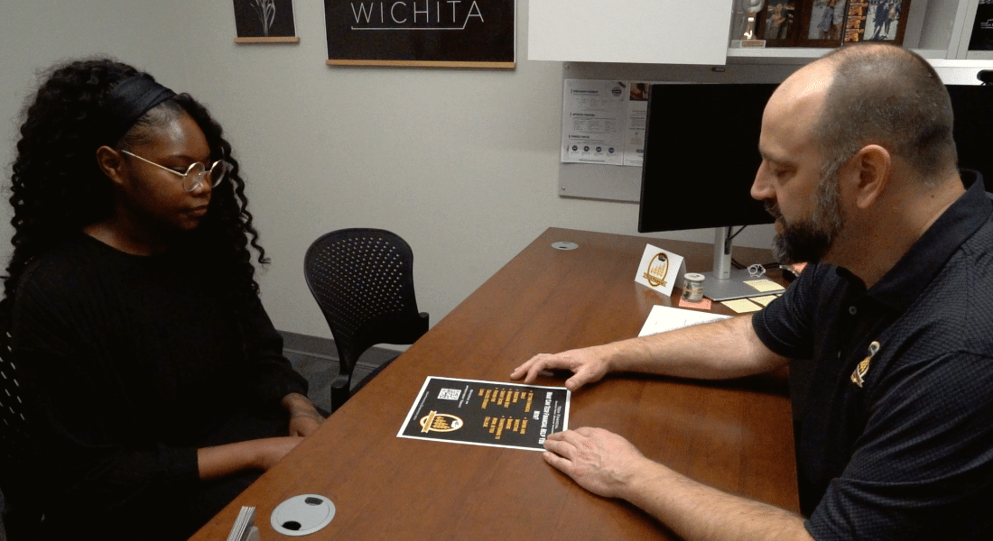 tech-financial-what-to-expect-6 Student meets with a WSU Tech staff member in an office to discuss financial aid and college funding options.