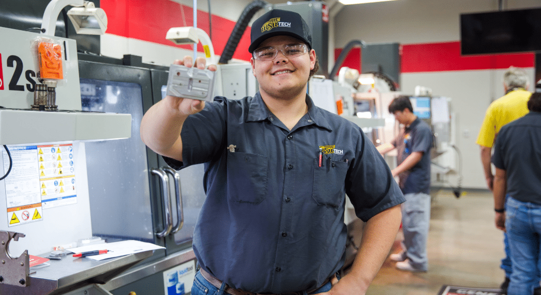 Capital Campaign 2026 Imagery-1 WSU Tech machining student holds a completed metal component while training in an advanced manufacturing lab.