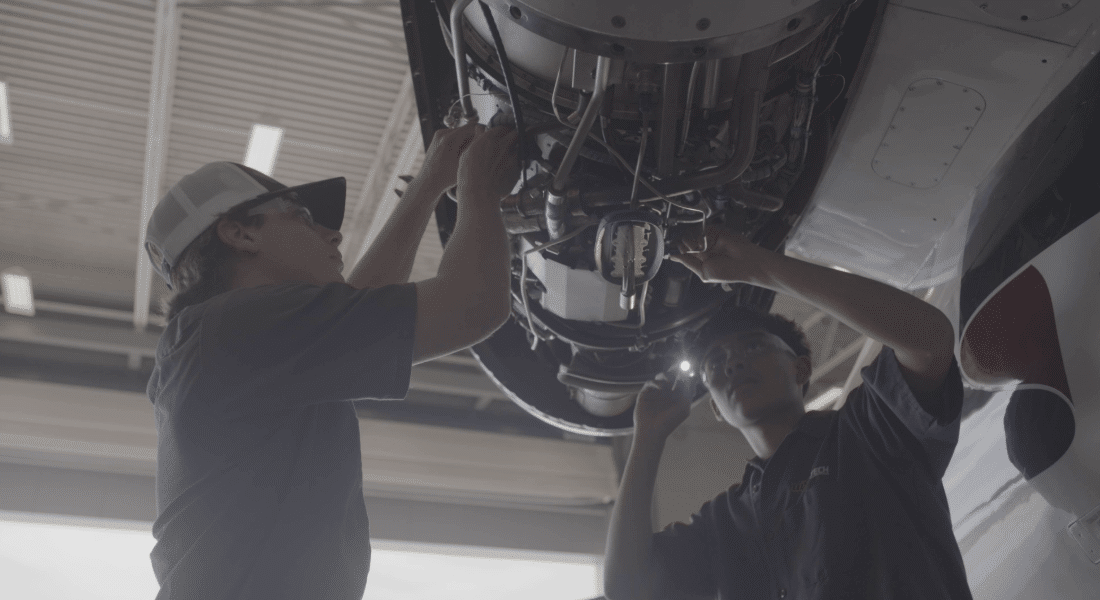 Capital Campaign 2026 Imagery-12 Two WSU Tech students perform hands-on aircraft maintenance training beneath an aircraft.