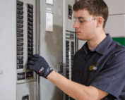WSU Tech HVAC student works on an electrical panel during hands-on technical training.