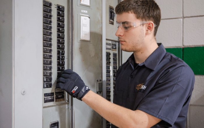 WSU Tech HVAC student works on an electrical panel during hands-on technical training.