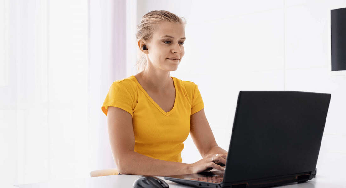 canvas-nav-support-student-resources-hub Student uses a laptop to access Canvas and online course resources.