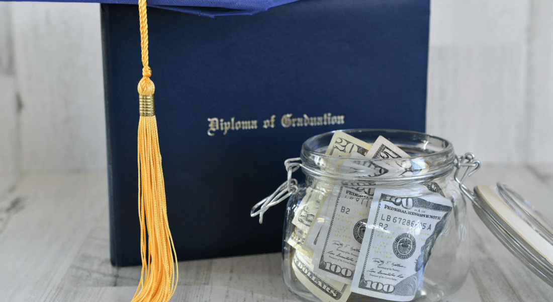 paying-for-college-student-resources-hub Graduation cap and diploma beside a jar of money, representing financial planning and resources for paying for college.