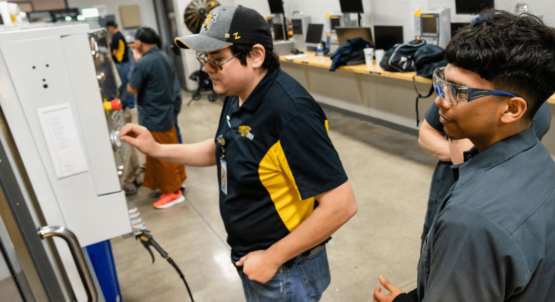 TWI-Student_Resources_HUB Students working with industrial equipment in a technical lab.